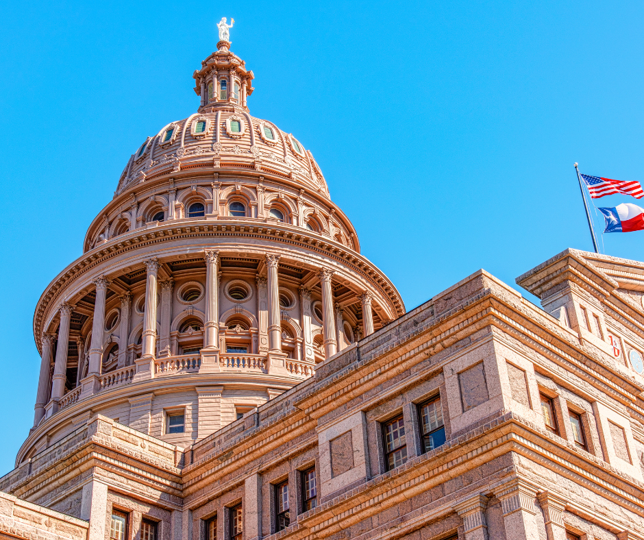 The Texas State Capitol building flying the US and Texas flag